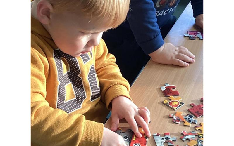 Child doing a jigsaw puzzle