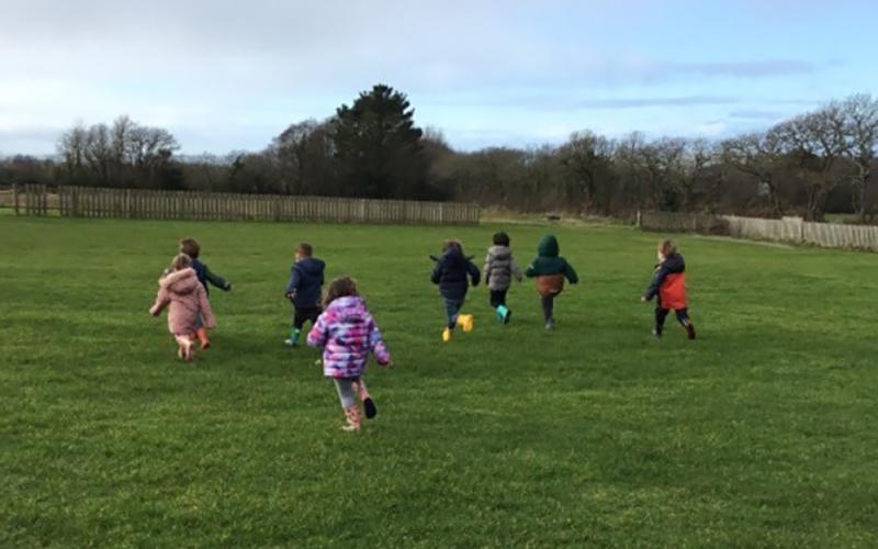 Children running across a field