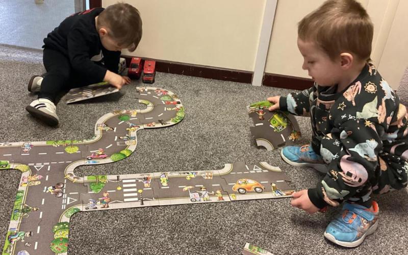Children building a puzzle road