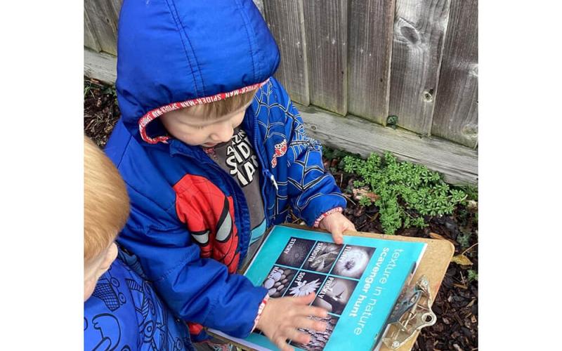 Children with a scavenger hunt clipboard